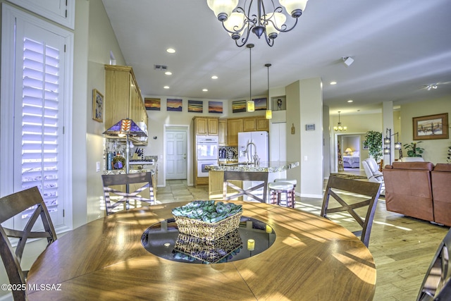 13517 N Heritage Gateway Ave, Marana, AZ 85658 - dining room featuring light wood finished floors, visible vents, baseboards, recessed lighting, and a notable chandelier