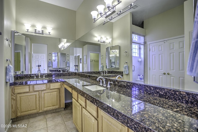 13517 N Heritage Gateway Ave, Marana, AZ 85658 - bathroom featuring tile patterned floors, a notable chandelier, double vanity, and a sink