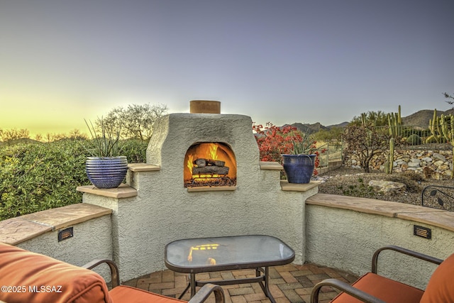 13517 N Heritage Gateway Ave, Marana, AZ 85658 - balcony featuring a mountain view, a lit fireplace, and a patio area