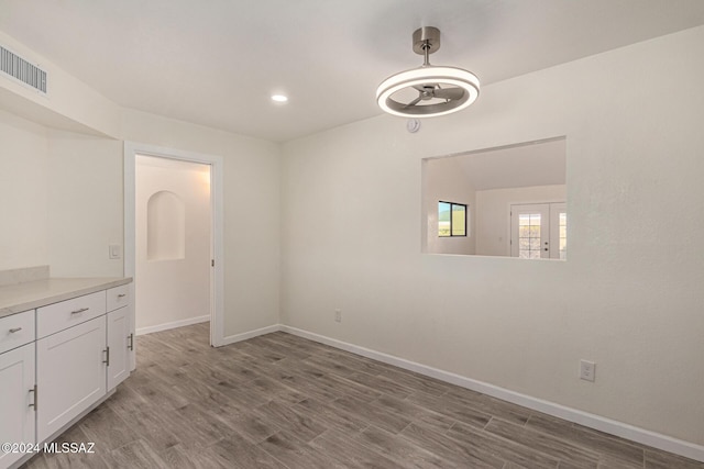 unfurnished dining area with recessed lighting, wood finished floors, a ceiling fan, visible vents, and baseboards