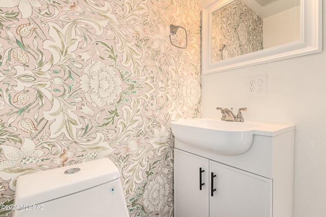 bathroom featuring toilet and vanity