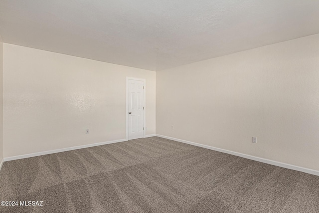 empty room with carpet and baseboards