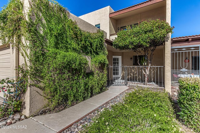 entrance to property featuring stucco siding