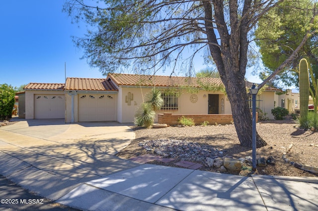 view of front facade featuring an attached garage, brick siding, a tile roof, concrete driveway, and stucco siding