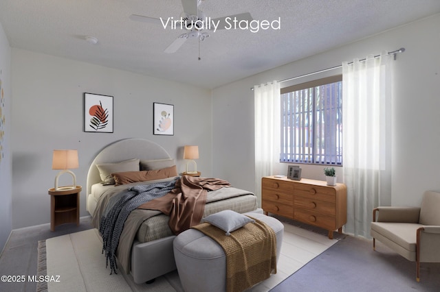 bedroom with a textured ceiling and ceiling fan