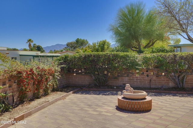 view of patio with a fenced backyard and a mountain view