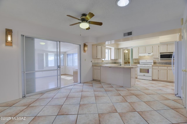 kitchen with under cabinet range hood, a peninsula, white appliances, visible vents, and light countertops