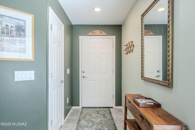 doorway to outside featuring baseboards