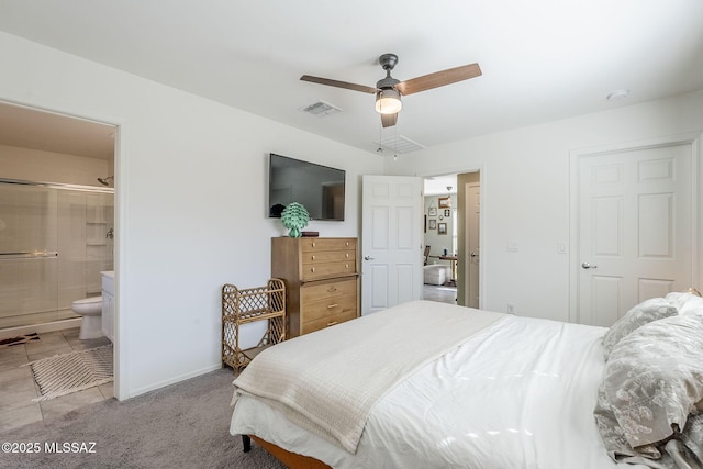 bedroom with ceiling fan, visible vents, baseboards, carpet, and ensuite bath