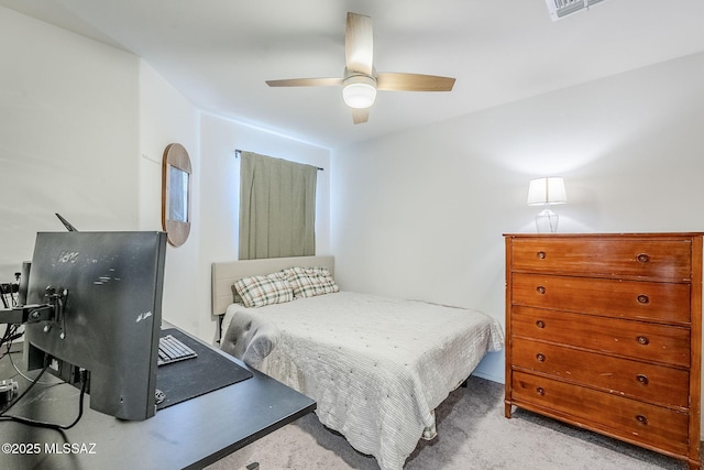 carpeted bedroom featuring ceiling fan and visible vents