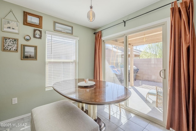 dining area with baseboards and light tile patterned floors