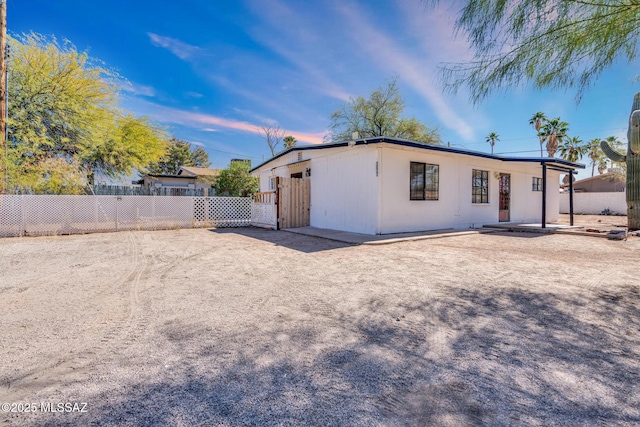 rear view of property featuring fence