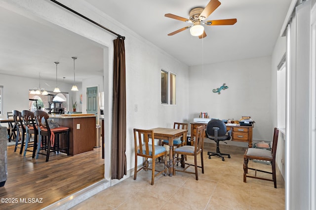 dining area with ceiling fan and light tile patterned floors