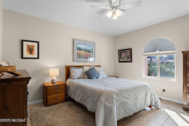 bedroom featuring light tile patterned floors, ceiling fan, and baseboards