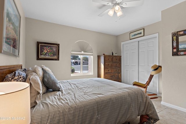 bedroom with a closet, ceiling fan, baseboards, and light tile patterned floors