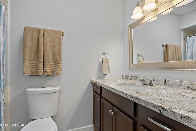 bathroom featuring a shower with curtain, vanity, toilet, and baseboards