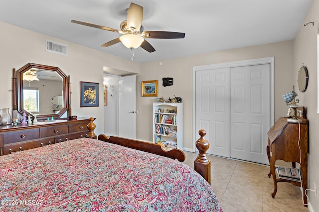 bedroom with a closet, visible vents, ceiling fan, and light tile patterned flooring