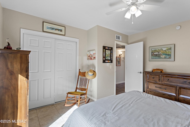 bedroom with a ceiling fan, a closet, visible vents, and light tile patterned flooring