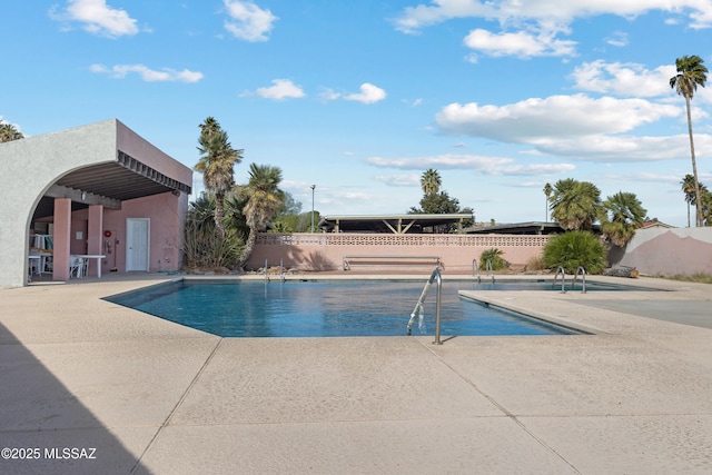 view of pool featuring a patio area, fence, and a fenced in pool