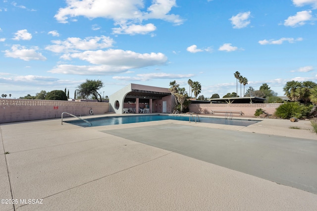 pool featuring a patio area and fence