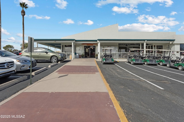 view of property featuring uncovered parking