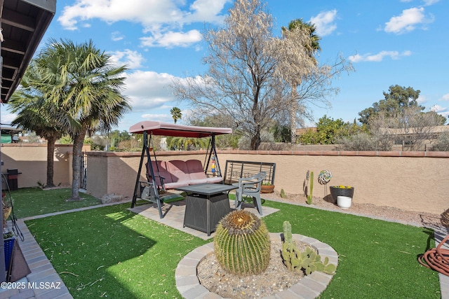 view of yard with an outdoor living space with a fire pit, fence, and a patio