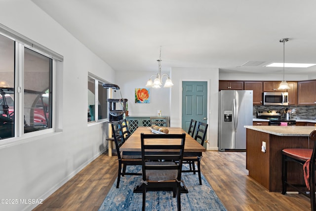 dining room with an inviting chandelier, visible vents, baseboards, and dark wood finished floors