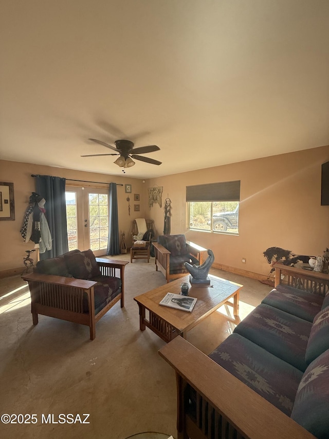 living room featuring a ceiling fan, french doors, and baseboards