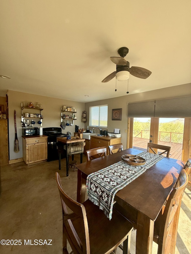 dining room with concrete flooring and ceiling fan