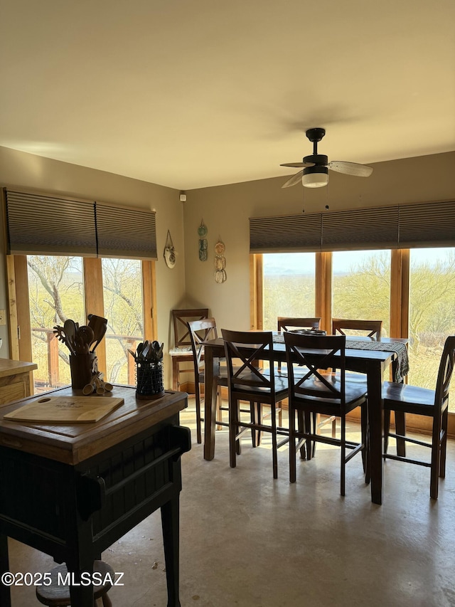 dining space with finished concrete flooring and a ceiling fan