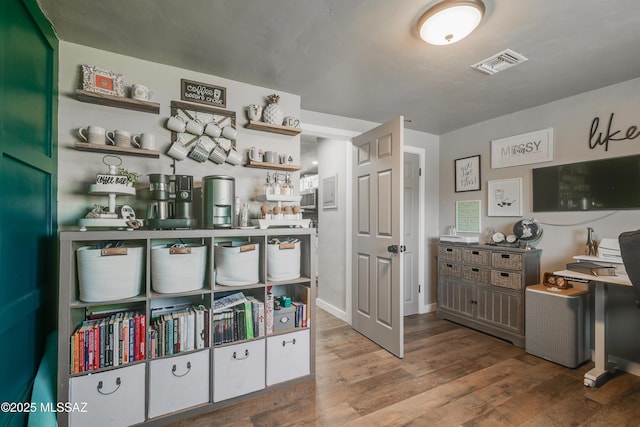 interior space featuring wood finished floors and visible vents