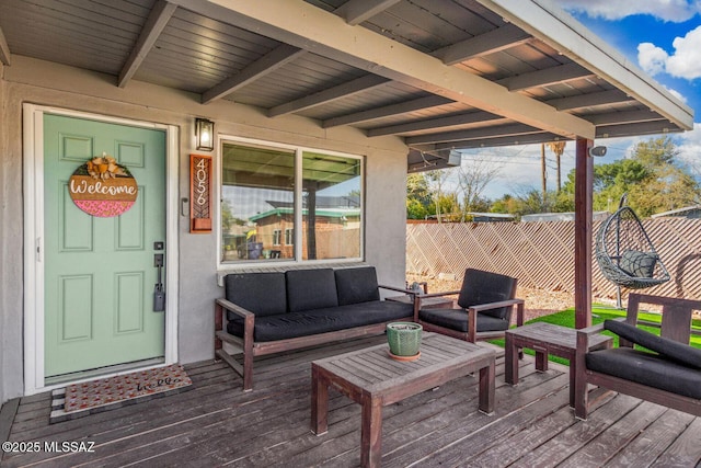 wooden terrace with fence and an outdoor living space