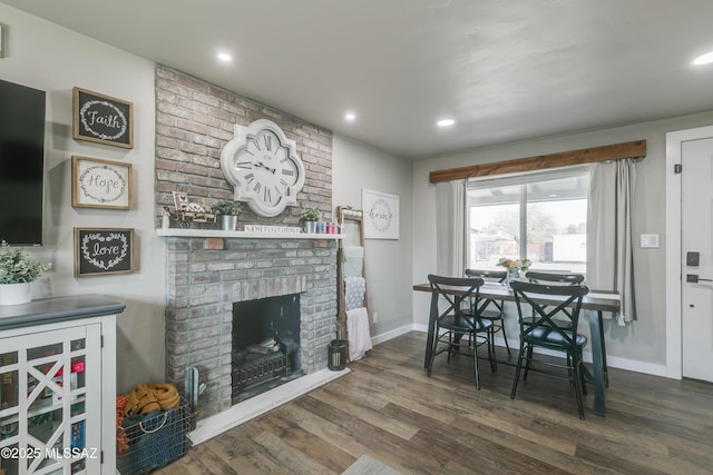 dining area featuring recessed lighting, a fireplace, wood finished floors, and baseboards