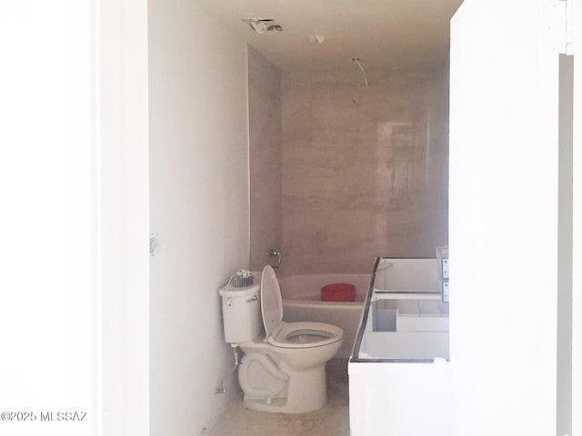 bathroom featuring a tub and toilet