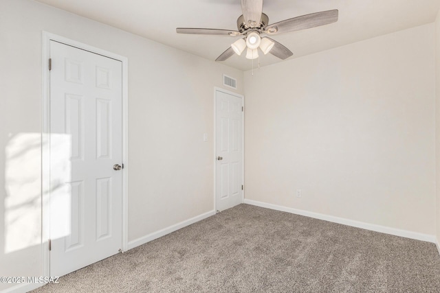 empty room featuring baseboards, visible vents, ceiling fan, and carpet flooring