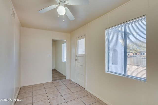 entrance foyer featuring ceiling fan, light tile patterned flooring, visible vents, and baseboards