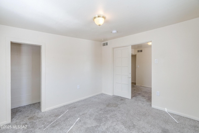 unfurnished bedroom featuring carpet, visible vents, and baseboards