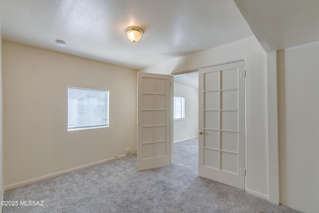 unfurnished room featuring baseboards and carpet flooring