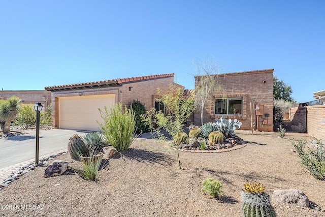 view of front of property with driveway, a garage, and fence