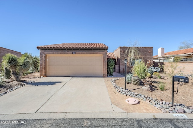 view of front of home featuring a garage, fence, and a tiled roof