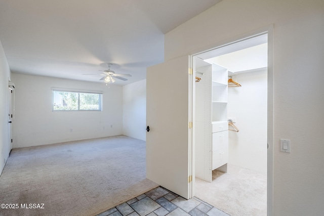 unfurnished room featuring light colored carpet and ceiling fan