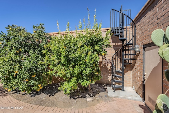 view of yard featuring fence and stairway