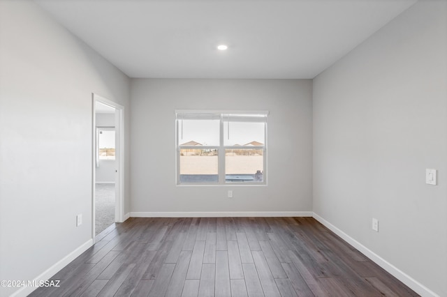 unfurnished bedroom featuring dark wood-style floors and baseboards