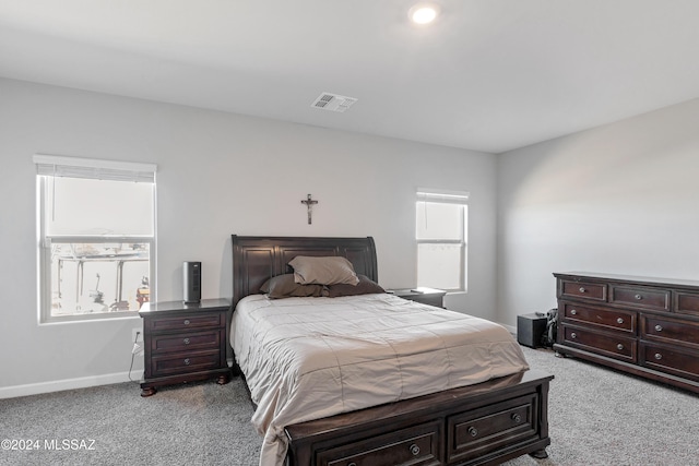 carpeted bedroom with visible vents and baseboards