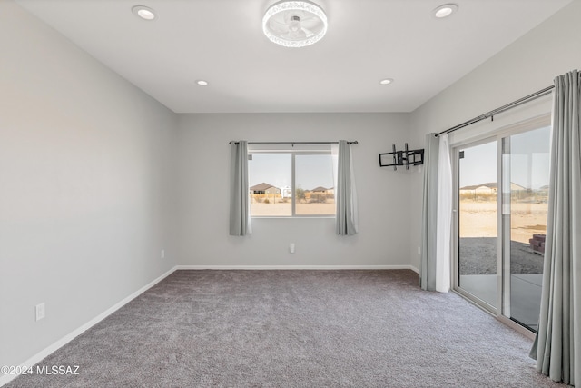 spare room with recessed lighting, carpet flooring, and baseboards