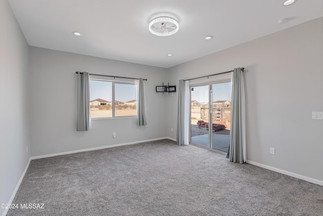 unfurnished room with recessed lighting, carpet, and baseboards