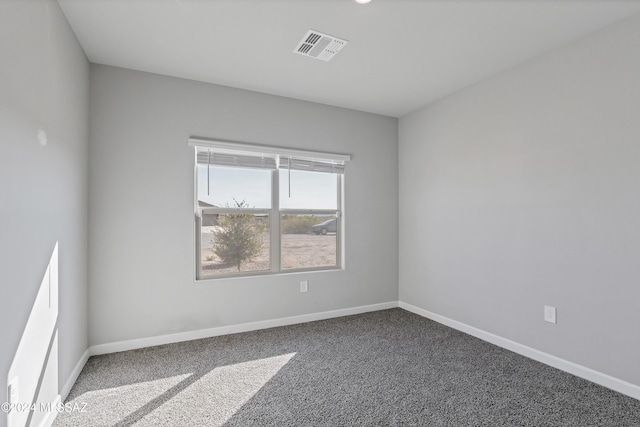 unfurnished room featuring baseboards, visible vents, and carpet flooring