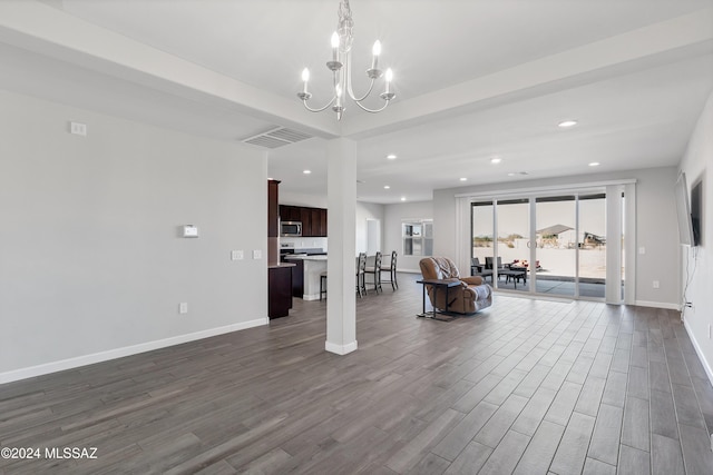 interior space featuring dark wood-style floors, baseboards, a notable chandelier, and recessed lighting