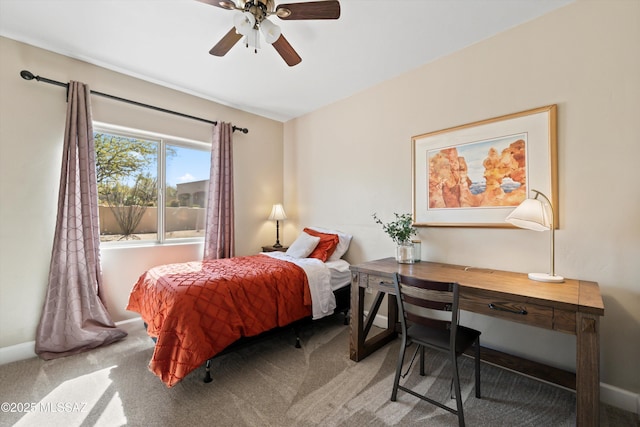 carpeted bedroom with baseboards and a ceiling fan