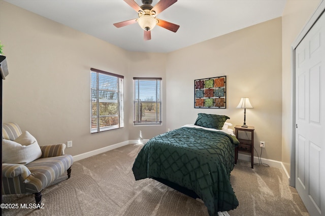 carpeted bedroom featuring a closet, a ceiling fan, and baseboards